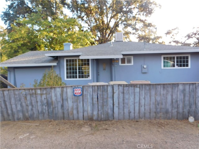 back of house with central AC unit