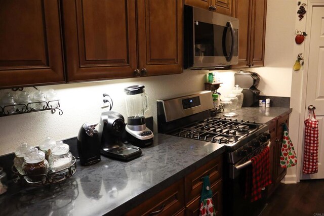 kitchen featuring dark hardwood / wood-style flooring and appliances with stainless steel finishes