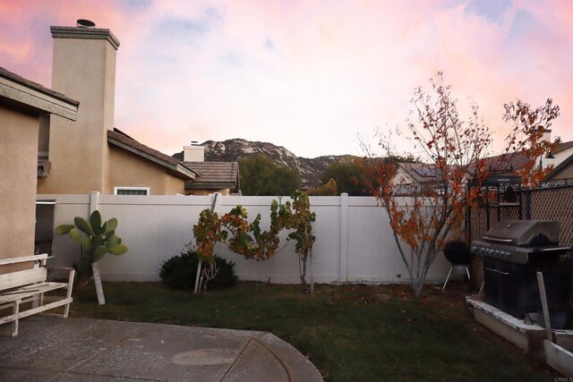 yard at dusk with a patio