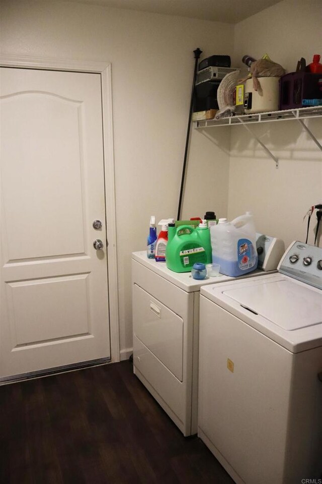 laundry room with washer and dryer and dark hardwood / wood-style floors