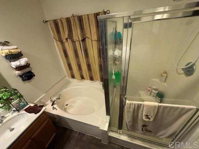 bathroom with vanity, hardwood / wood-style flooring, and independent shower and bath