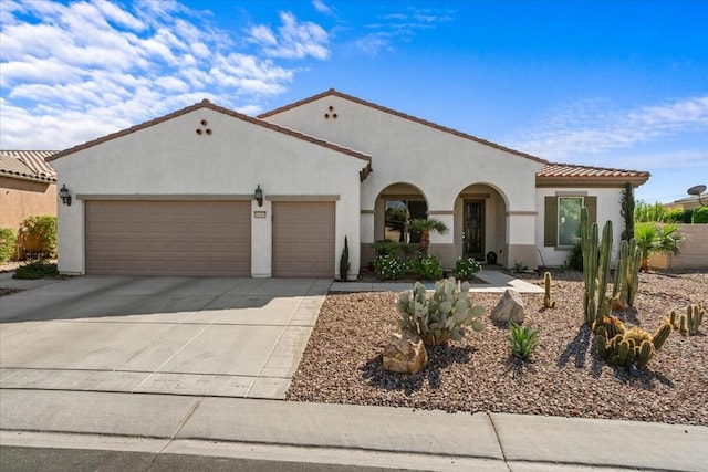 mediterranean / spanish-style home with a garage