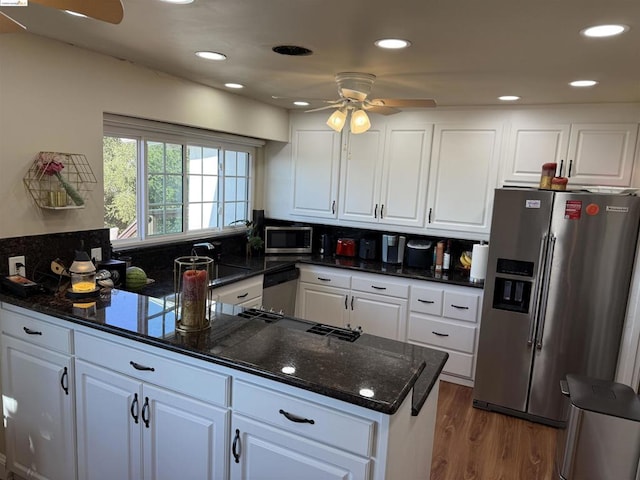 kitchen with hardwood / wood-style floors, ceiling fan, white cabinetry, and stainless steel appliances