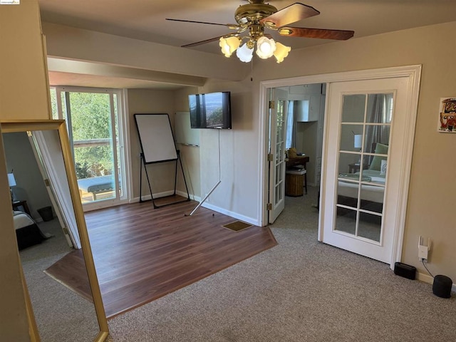 interior space featuring hardwood / wood-style floors, french doors, and ceiling fan