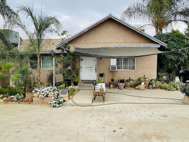 bungalow-style house featuring a patio area and cooling unit