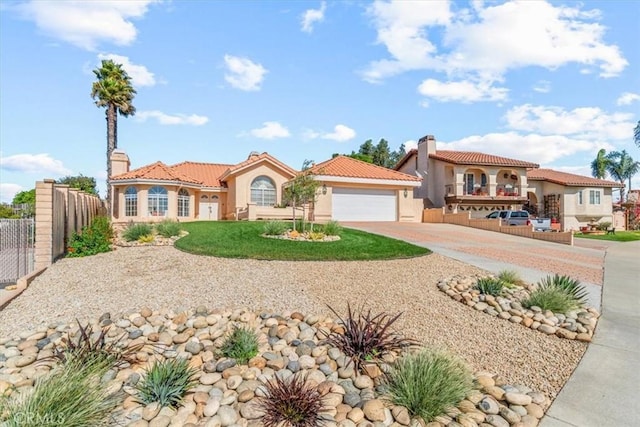 mediterranean / spanish home featuring a front lawn and a garage