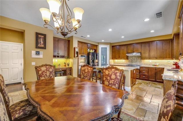 dining space featuring a chandelier