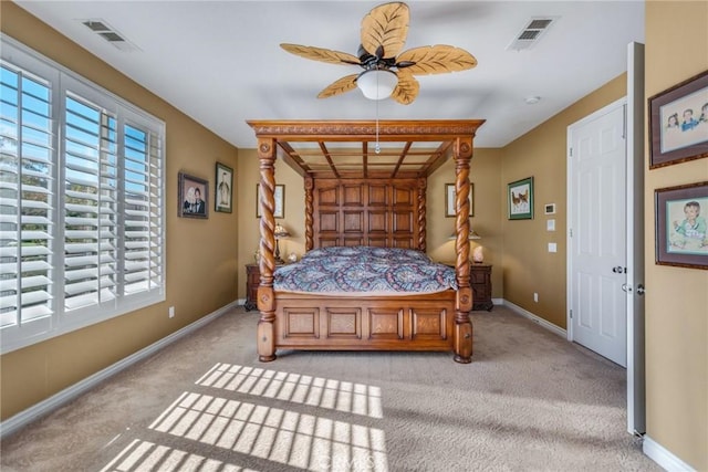 bedroom with ceiling fan, light colored carpet, and multiple windows