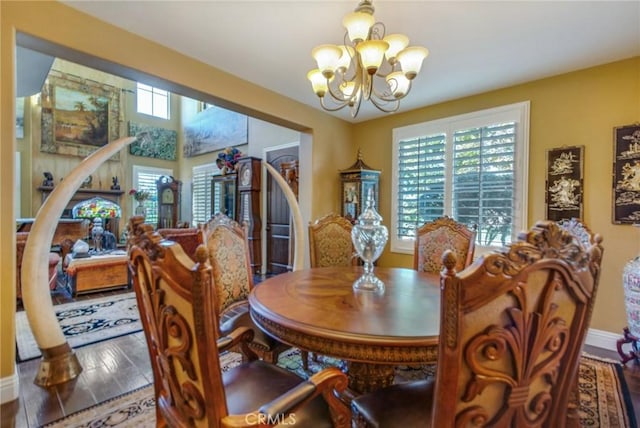 dining room featuring wood-type flooring and a notable chandelier