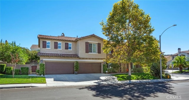 view of front of property with a garage and a front lawn