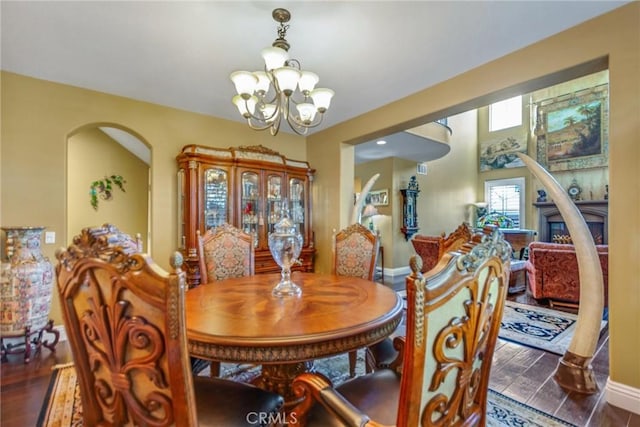 dining room with a notable chandelier and dark hardwood / wood-style floors