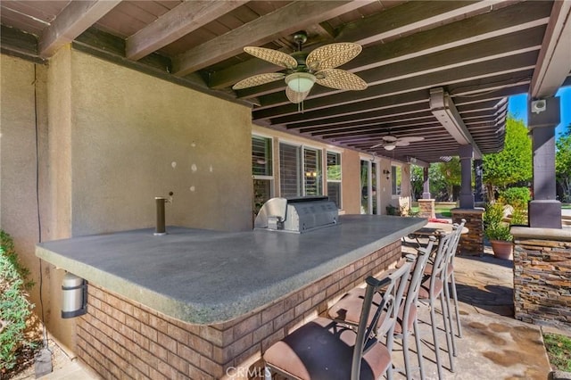 view of patio / terrace with ceiling fan, area for grilling, exterior bar, and grilling area