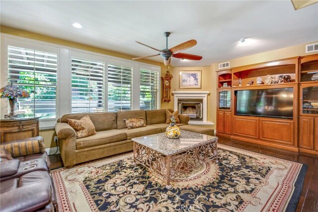 living room featuring dark hardwood / wood-style floors and ceiling fan