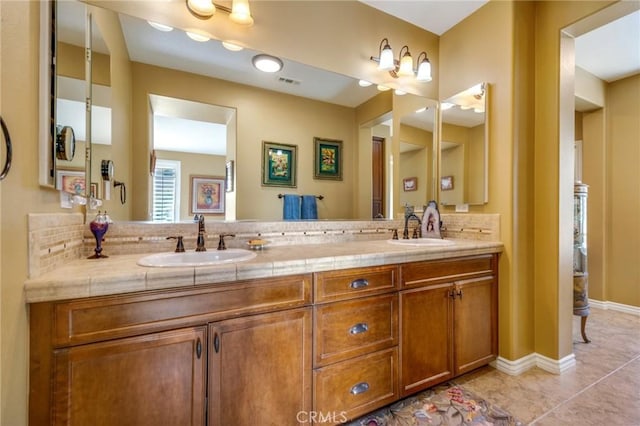 bathroom featuring backsplash, tile patterned flooring, and vanity