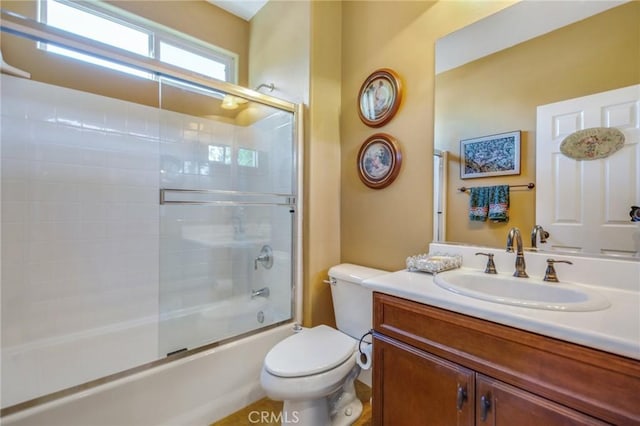 full bathroom with toilet, combined bath / shower with glass door, and vanity