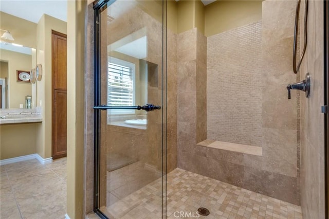 bathroom featuring tile patterned floors, vanity, and a shower with shower door