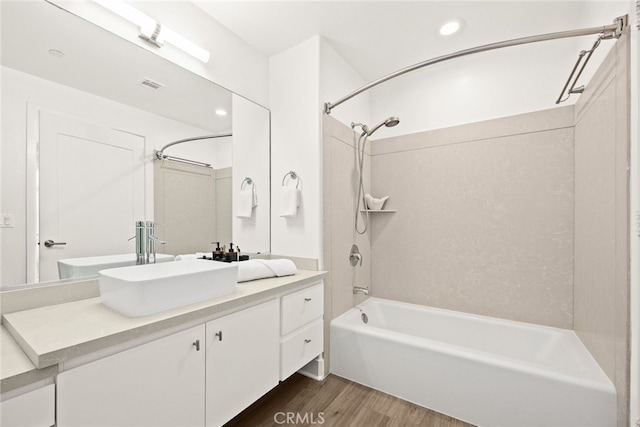 bathroom featuring vanity, wood-type flooring, and bathing tub / shower combination