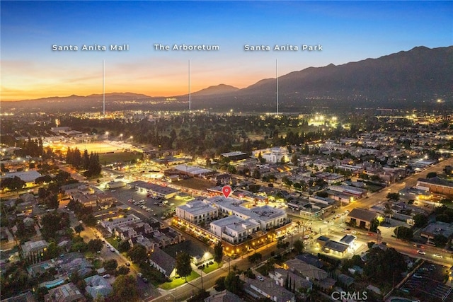 aerial view at dusk featuring a mountain view