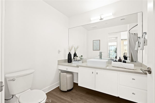 bathroom featuring vanity, curtained shower, toilet, and wood-type flooring