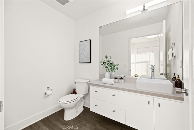 bathroom with vanity, hardwood / wood-style flooring, and toilet