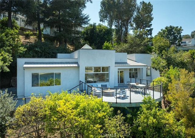 rear view of property with a deck