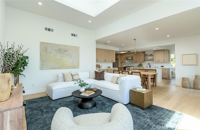 living room featuring sink and hardwood / wood-style flooring