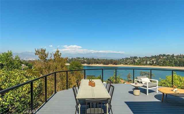 wooden terrace featuring a water view