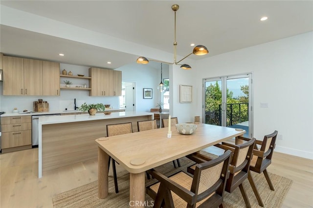 dining area with sink and light hardwood / wood-style flooring