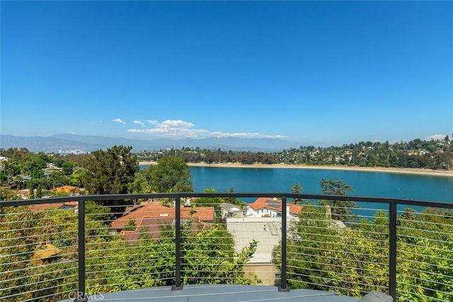 balcony featuring a water and mountain view