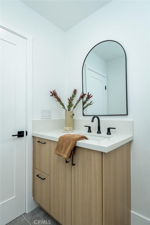 bathroom with tile patterned flooring and vanity