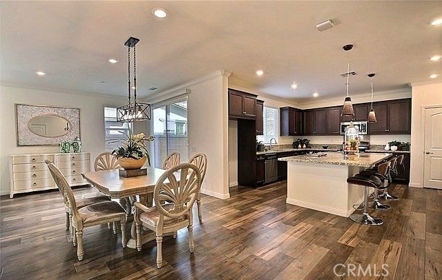 dining area with sink and dark hardwood / wood-style flooring