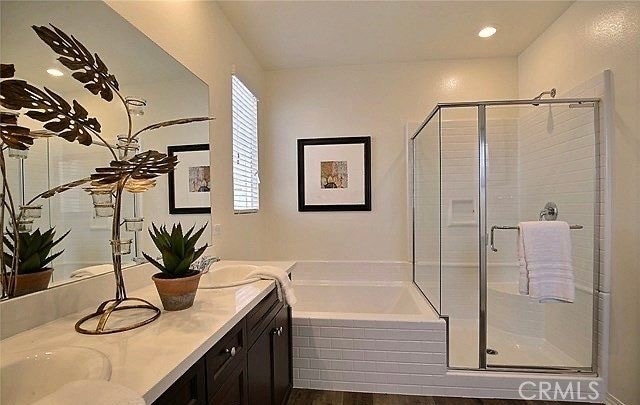 bathroom with vanity, independent shower and bath, and wood-type flooring