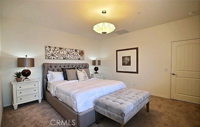 bedroom featuring dark carpet