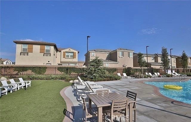 view of swimming pool with a patio and a lawn