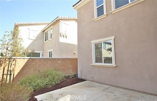 view of side of home with a patio area