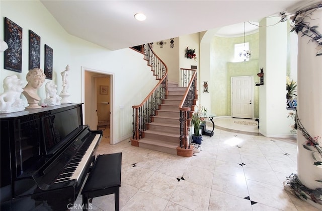 505 Lowe Dr, Placentia, CA 92870 - entrance foyer featuring arched walkways, a towering ceiling, stairs, light tile patterned floors, and recessed lighting