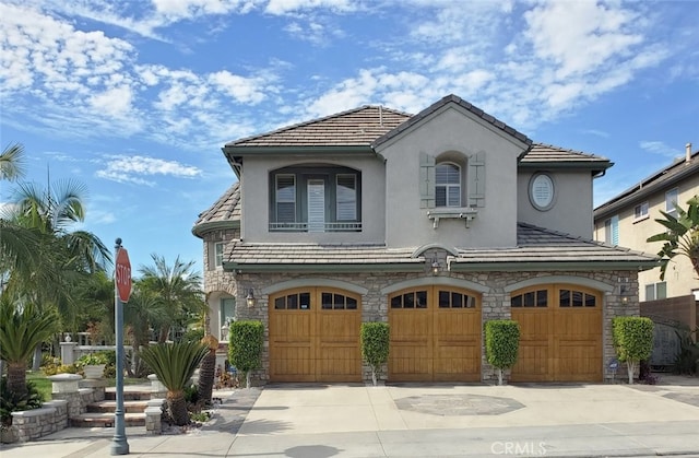 505 Lowe Dr, Placentia, CA 92870 - view of front of house with stone siding, stucco siding, an attached garage, and driveway