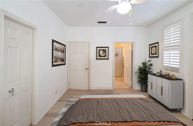 unfurnished bedroom with light wood-style flooring, visible vents, ceiling fan, and baseboards