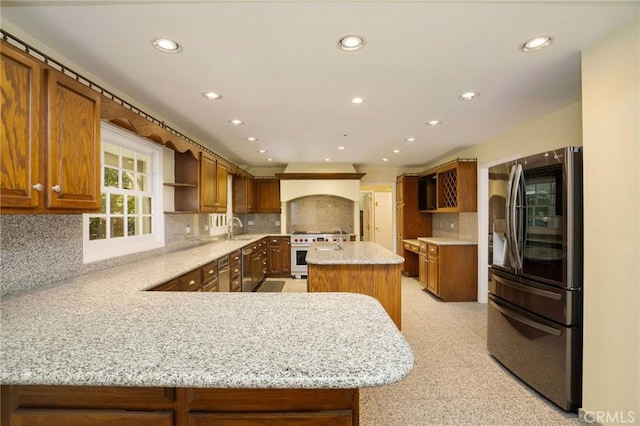 kitchen with brown cabinetry, open shelves, stainless steel appliances, and a sink