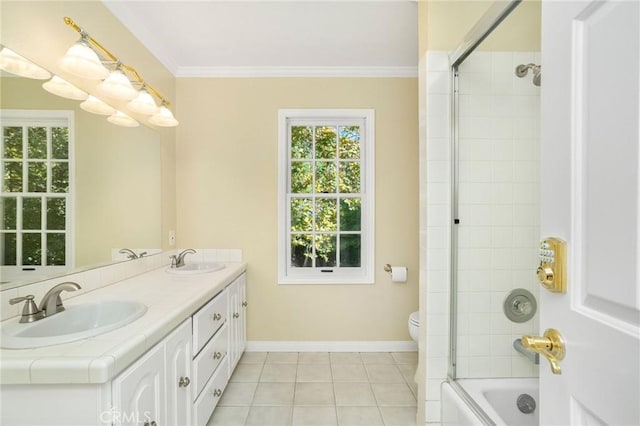 full bath featuring crown molding, double vanity, baseboards, and a sink