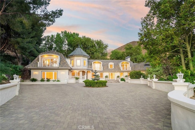 back of house at dusk with french doors