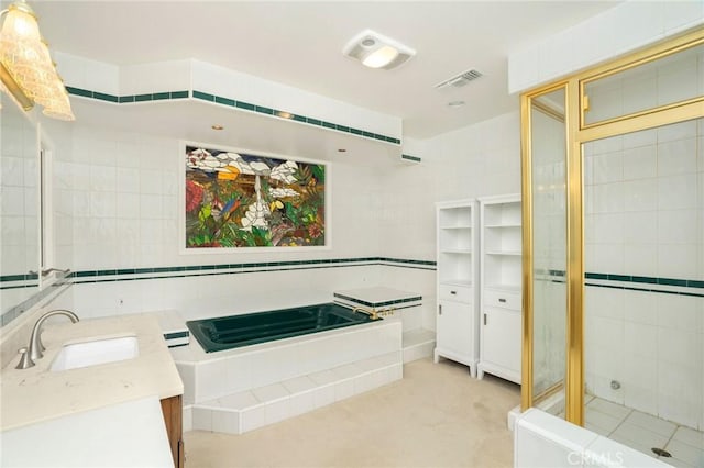 full bathroom featuring vanity, a bath, visible vents, and tiled shower