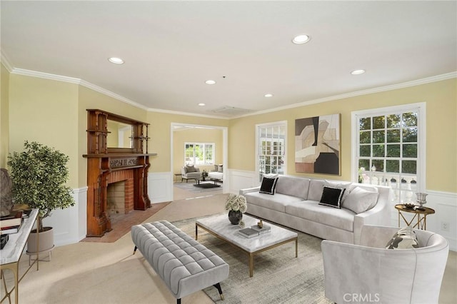 living area with ornamental molding, carpet floors, recessed lighting, wainscoting, and a fireplace