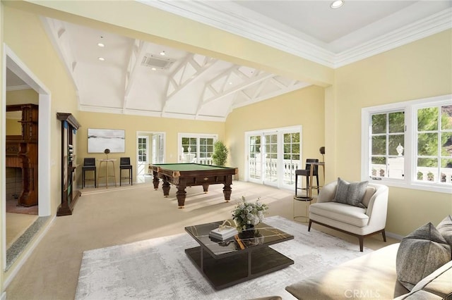 playroom featuring light carpet, a healthy amount of sunlight, french doors, and a towering ceiling