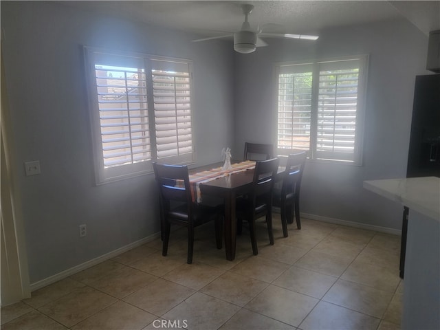 tiled dining room with ceiling fan