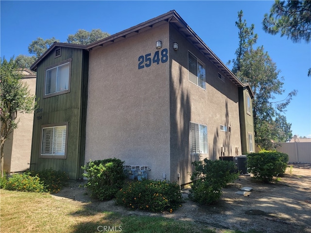 view of side of property with central AC unit