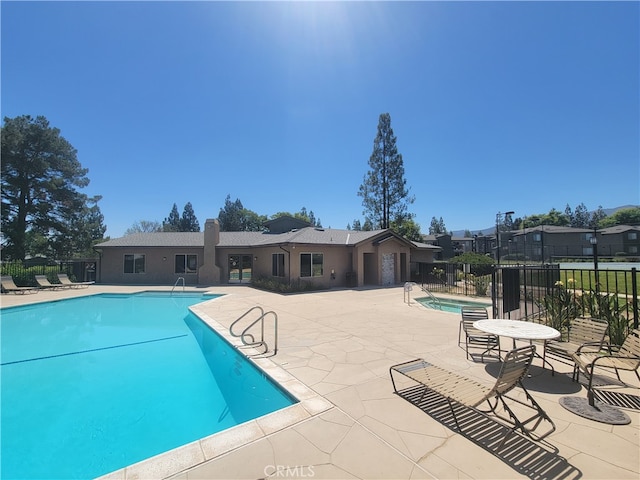 view of swimming pool with a patio area