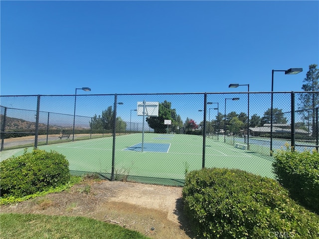 view of tennis court featuring basketball court