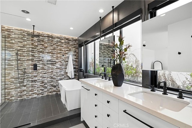 bathroom featuring tile patterned floors, vanity, and a bathtub