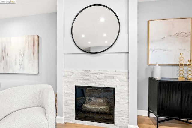 interior space featuring light wood-type flooring and a fireplace